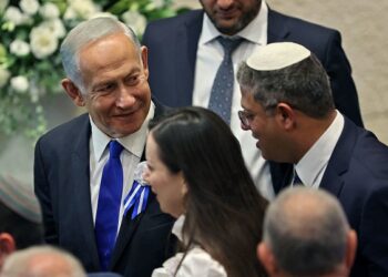 Israeli right wing Knesset member Itamar ben Gvir (R) chats with incoming Prime Minister Benjamin Netanyahu (L) during the swearing in ceremony of the new Israeli government at the Knesset (Israeli parliament) in Jerusalem, on November 15, 2022. - Israel swore in a new parliament today hours after a deadly attack, as veteran hawk Benjamin Netanyahu advances talks on forming what could be the country's most right-wing government ever. (Photo by ABIR SULTAN / POOL / AFP) (Photo by ABIR SULTAN/POOL/AFP via Getty Images)