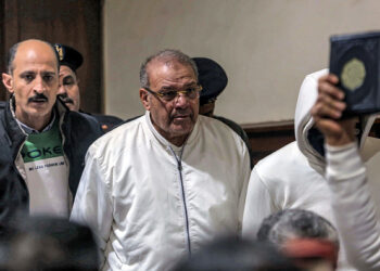 Egyptian businessman Hassan Ratib (C) attends a trial session over charges of illegal excavation and trafficking of antiquities, in Egypt's capital Cairo on January 8, 2022. - Ratib was charged of trade in looted artifacts that were embezzled by financed excavations in separate areas throughout the country to sell them inside the country and smuggle them abroad for the same purpose. (Photo by Khaled KAMEL / AFP) (Photo by KHALED KAMEL/AFP via Getty Images)