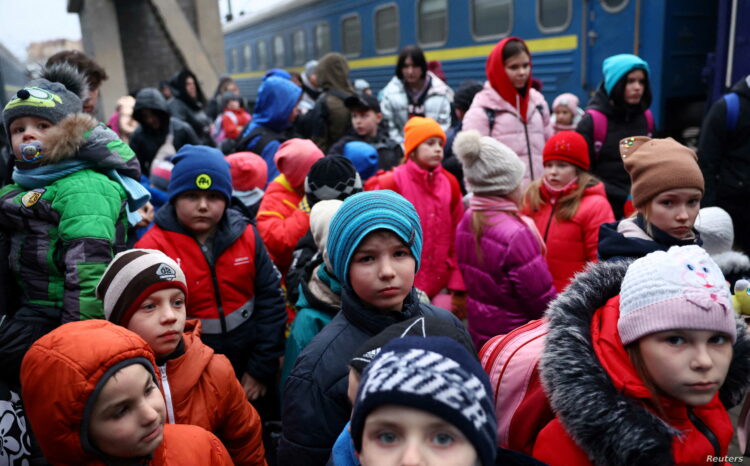 A group of children evacuated from an orphanage in Zaporizhzhia wait to board a bus for their transfer to Poland after fleeing the ongoing Russian invasion at the main train station in Lviv, Ukraine, March 5, 2022.   REUTERS/Kai Pfaffenbach REFILE - CORRECTING INFORMATION