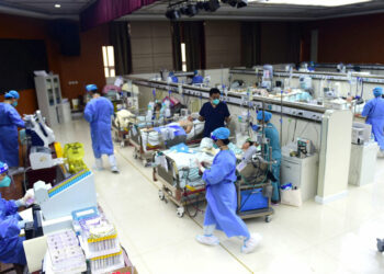 FILE PHOTO: Medical workers attend to patients of the coronavirus disease (COVID-19) at an intensive care unit (ICU) converted from a conference room, at a hospital in Cangzhou, Hebei province, China January 11, 2023. China Daily via REUTERS  ATTENTION EDITORS - THIS IMAGE WAS PROVIDED BY A THIRD PARTY. CHINA OUT./File Photo