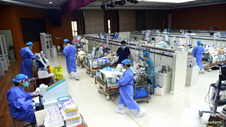 FILE PHOTO: Medical workers attend to patients of the coronavirus disease (COVID-19) at an intensive care unit (ICU) converted from a conference room, at a hospital in Cangzhou, Hebei province, China January 11, 2023. China Daily via REUTERS  ATTENTION EDITORS - THIS IMAGE WAS PROVIDED BY A THIRD PARTY. CHINA OUT./File Photo