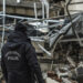 A police officer stands next to a destroyed building as he searches with emergency teams for people in Gaziantep, Turkey, Monday, Feb. 6, 2023. A powerful quake has knocked down multiple buildings in southeast Turkey and Syria and many casualties are feared. (AP Photo/Mustafa Karali)