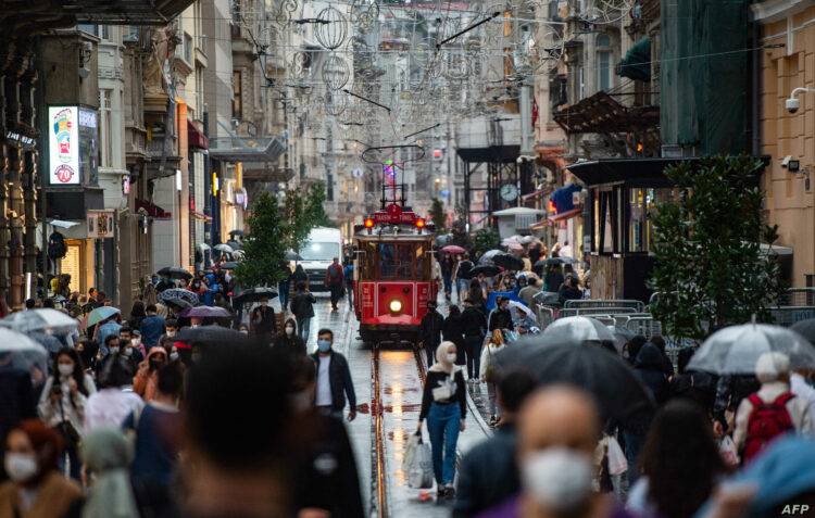 People wearing face masks walk on Istiklal Street, in Istanbul, on October 9, 2020. (Photo by Yasin AKGUL / AFP)