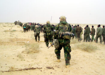 030321-M-3692W-053
U.S. Marines from the 2nd Battalion, 1st Marine Regiment escort captured enemy prisoners of war to a holding area in the desert of Iraq on March 21, 2003, during Operation Iraqi Freedom.  Operation Iraqi Freedom is the multinational coalition effort to liberate the Iraqi people, eliminate Iraq's weapons of mass destruction and end the regime of Saddam Hussein.  DoD photo by Lance Cpl. Brian L. Wickliffe, U.S. Marine Corps.