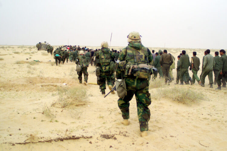 030321-M-3692W-053
U.S. Marines from the 2nd Battalion, 1st Marine Regiment escort captured enemy prisoners of war to a holding area in the desert of Iraq on March 21, 2003, during Operation Iraqi Freedom.  Operation Iraqi Freedom is the multinational coalition effort to liberate the Iraqi people, eliminate Iraq's weapons of mass destruction and end the regime of Saddam Hussein.  DoD photo by Lance Cpl. Brian L. Wickliffe, U.S. Marine Corps.