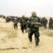 030321-M-3692W-053
U.S. Marines from the 2nd Battalion, 1st Marine Regiment escort captured enemy prisoners of war to a holding area in the desert of Iraq on March 21, 2003, during Operation Iraqi Freedom.  Operation Iraqi Freedom is the multinational coalition effort to liberate the Iraqi people, eliminate Iraq's weapons of mass destruction and end the regime of Saddam Hussein.  DoD photo by Lance Cpl. Brian L. Wickliffe, U.S. Marine Corps.