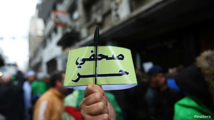 Algerian journalists demonstrate for freedom of the press during a protest against the country's ruling elite and rejecting the December presidential election in Algiers, Algeria November 15, 2019. The armband reads "Free journalist." REUTERS/Ramzi Boudina