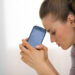 Portrait of stressed young woman with cell phone