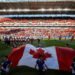 Kids hold a Canadian flag during the national anthem before the Toronto FC play D.C. United in their MLS soccer match, at BMO Field, a venue for the 2026 FIFA World Cup, in Toronto, Ontario, Canada, June 13, 2018.    REUTERS/Mark Blinch