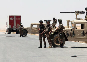 Jordanian soldiers stand guard near their military vehicles at the Al-Karameh border point with Iraq on June 25, 2014 as Jordan reinforced its border with Iraq after Sunni Arab militants overran a crossing with Syria. Sunni insurgents led by the jihadist Islamic State of Iraq and the Levant (ISIL) overran swathes of land north and west of Baghdad this month sparking fears in Amman that they will take the fight to Jordan, which is already struggling with its own home-grown Islamists.    AFP PHOTO/STR