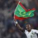 Mauritania's midfielder #8 Bodda Mouhsine holds a Mauritania flag after his team won the Africa Cup of Nations (CAN) 2024 group D football match between Mauritania and Algeria at Stade de la Paix in Bouake on January 23, 2024. (Photo by KENZO TRIBOUILLARD / AFP)