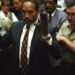 O.J. Simpson holds up his hands to the jury wearing the infamous gloves found at the crime scene and his home in this June 15, 1995 file photo. More than a decade after he was acquitted of charges that he murdered his ex-wife Nicole Brown Simpson and her friend Ron Goldman, O.J. will describe in a televised interview how he would have committed the crime if he was the one responsible in a special to air on the Fox Network November 27 and 29, 2006. REUTERS/Sam Mircovich/Files (UNITED STATES)   BEST QUALITY AVAILABLE