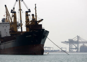 A ship is docked outside the container terminal at the southern Yemeni port of Aden June 16, 2010. Somali pirates trawl the sea south of the Bab al-Mandab strait off Yemen's coast, and in recent months have stepped up attacks on tankers, cargo ships and fishing vessels in defiance of a major crackdown by navies from at least a dozen countries. But Yemen has deeper worries about security off its coast after a resurgent al Qaeda arm called for a blockade of the strait between the Red Sea and the Gulf of Aden, through which 25,000 ships -- 7 percent of world shipping -- pass each year. Picture taken June 16, 2010. To match feature YEMEN-SHIPPING/ REUTERS/Khaled Abdullah (YEMEN - Tags: TRANSPORT BUSINESS)