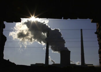 The window of a demolished house frames a chimney as it billows smoke from a nearby coal-burning power station in Beijing December 14, 2010. China will insist on keeping its greenhouse gas output free of any binding climate treaty fetters, a senior Chinese diplomat said, dismissing an earlier report that suggested a softening of Beijing's position as a "misunderstanding." The recent two-week climate change meeting in Cancun, Mexico showed an ever-broader belief that a legally binding deal is far off, partly because of opposition by China and the United States, the world's top emitters of greenhouse gases.   REUTERS/David Gray (CHINA - Tags: ENVIRONMENT SOCIETY BUSINESS POLITICS IMAGES OF THE DAY)