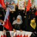 Protesters hold banners with photos of political prisoners asking for their release, as they march during an anti-government protest organised by Bahrain's main opposition party Al Wefaq in Budaiya, west of Manama, May 9, 2014.  REUTERS/Hamad I Mohammed (BAHRAIN - Tags: POLITICS CIVIL UNREST)