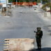 Israeli soldiers stand guard on a blocked road, as the entrance to Hebron is closed, in the Israeli-occupied West Bank, October 8, 2023. REUTERS/Mussa Qawasma