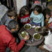 Displaced Palestinian man Wael Al-Attar eats Khobiza, a wild leafy vegetable, with his family as they break their fast during the holy month of Ramadan, at a school where they shelter, amid the ongoing conflict between Israel and Hamas, in Jabalia in the northern Gaza Strip, March 22, 2024. REUTERS/Mahmoud Issa