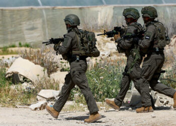 Members of the Israeli army inspect the scene of a shooting incident, near Jericho in the Israeli-occupied West Bank, March 28, 2024. REUTERS/Ammar Awad