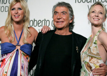 FILE PHOTO: Italian fashion designer Roberto Cavalli poses with Nicky Hilton (L) and actress Anne Heche (R) at the launch party for Roberto Cavalli Vodka in Los Angeles May 11, 2006. Cavalli introduced his ultra-premium vodka, retailing at $60 per bottle, in his first epicurean venture in the U.S.. REUTERS/Mario Anzuoni/File Photo
