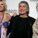 FILE PHOTO: Italian fashion designer Roberto Cavalli poses with Nicky Hilton (L) and actress Anne Heche (R) at the launch party for Roberto Cavalli Vodka in Los Angeles May 11, 2006. Cavalli introduced his ultra-premium vodka, retailing at $60 per bottle, in his first epicurean venture in the U.S.. REUTERS/Mario Anzuoni/File Photo