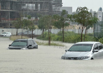 Cars drive through a flooded street during a rain storm in Dubai, United Arab Emirates, April 16, 2024. REUTERS/Abdel Hadi Ramahi