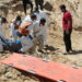 People work to move into a cemetery bodies of Palestinians killed during Israel's military offensive and buried at Nasser hospital, amid the ongoing conflict between Israel and the Palestinian Islamist group Hamas, in Khan Younis in the southern Gaza Strip, April 21, 2024. REUTERS/Ramadan Abed