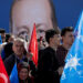 Supporters of Turkey's President Tayyip Erdogan listen to his speech as they hold flags during a rally ahead of the local elections in Istanbul, Turkey March 30, 2024. REUTERS/Umit Bektas