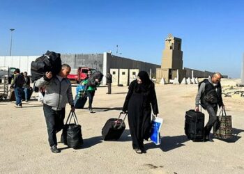 Passengers returning to the Gaza Strip arrive at the Egyptian side of the Rafah border crossing in the north eastern Sinai province, hours after the start of a four-day truce in battles between Israel and Palestinian Hamas militants, on November 24, 2023. A four-day truce in the Israel-Hamas war began on November 24, with hostages set to be released in exchange for Palestinian prisoners in the first major reprieve in seven weeks of war that have claimed thousands of lives. (Photo by AFP)