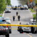 Police officers work at the scene where police shot and injured a suspect who was walking down a city street carrying a gun, as four nearby schools were placed on lockdown, in Toronto, Ontario, Canada, May 26, 2022. REUTERS/Chris Helgren     TPX IMAGES OF THE DAY