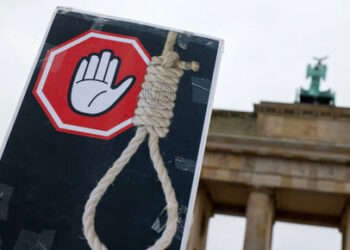 A placard is seen during a protest against the Islamic regime of Iran following the death of Mahsa Amini, in Berlin, Germany, December 10, 2022. REUTERS/Michele Tantussi