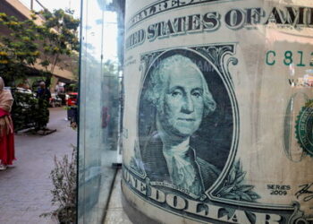 People walk past a currency exchange point, displaying an image of the U.S. dollar, in Cairo, Egypt, March 6, 2024. REUTERS/Mohamed Abd El Ghany