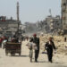 Palestinians carry aid as others struggle to receive their portion amid a widespread hunger, as the conflict between Israel and the Palestinian Islamist group Hamas continues, in Gaza City April 3, 2024. REUTERS/Mahmoud Issa