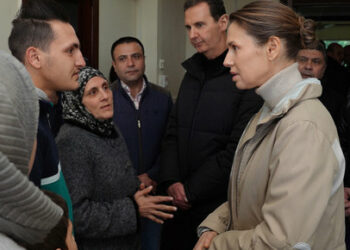 A handout picture released by the official Syrian Arab News Agency (SANA)on February 11, 2023, shows Syria's President Bashar al-Assad (L) and first lady Asma al-Assad (R) visiting families affected by the earthquake, at the  Basil Al-Assad Center for Educational Training in Latakia, on February 11, 2023. - The 7.8-magnitude quake struck early on February 6 as people slept, in a region where many had already suffered loss and displacement due to Syria's civil war. (Photo by SANA / AFP) / == RESTRICTED TO EDITORIAL USE - MANDATORY CREDIT "AFP PHOTO / HO /SYRIAN ARAB NEWS AGENCY SANA" - NO MARKETING NO ADVERTISING CAMPAIGNS - DISTRIBUTED AS A SERVICE TO CLIENTS ==