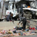 Workers inspect the wreckage of a car at the site of a road accident near the town of Al-Saff in Cairo's northern Giza province, some 40 kilometres North of the capital, on March 26, 2020, which left several people killed and wounded. (Photo by Khaled KAMEL / AFP)