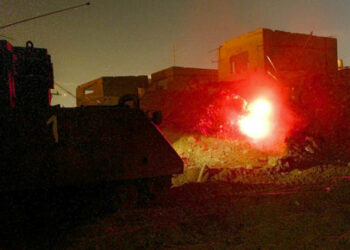 Israeli soldiers fire from their armoured personnel carrier as they
blow-up a Palestinian smuggling tunnel under a destroyed home November
18, 2003 in the Rafah refugee camp in the Gaza Strip. The Palestinian
tunnels run under the border between Gaza and Egypt and are primarily
used for smuggling weapons and ammunition to the Gaza Strip.
REUTERS/Gil Cohen Magen

RKR