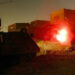 Israeli soldiers fire from their armoured personnel carrier as they
blow-up a Palestinian smuggling tunnel under a destroyed home November
18, 2003 in the Rafah refugee camp in the Gaza Strip. The Palestinian
tunnels run under the border between Gaza and Egypt and are primarily
used for smuggling weapons and ammunition to the Gaza Strip.
REUTERS/Gil Cohen Magen

RKR