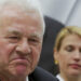 Austrian-Canadian billionaire Frank Stronach listens next to his party whip Katrin Nachbaur during a news conference in Vienna January 28, 2014. Stronach is resigning from Austria's parliament, he said on Tuesday, 16 month after founding a party that he hoped would reshape the political landscape but that fell short of his ambitions. "I will announce in parliament tomorrow that I am giving up my seat," the 81-year-old auto parts magnate told a news conference, adding he would remain chairman of Team Stronach for the time being but play a less active role in the party.      REUTERS/Leonhard Foeger  (AUSTRIA - Tags: POLITICS)