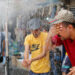 People cool off under an outdoor shower as the temperature soars in Baghdad, Iraq July 28, 2020. REUTERS/Thaier Al-Sudani