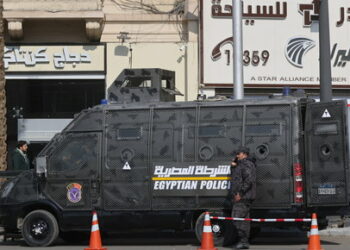 People walk next to an Egyptian riot police vehicle guarding at Tahrir Square, ahead of the anniversary of the 2011 Egyptian revolution, in Cairo, Egypt January 17, 2023. REUTERS/Amr Abdallah Dalsh