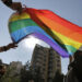 FILE - Activists from the Lesbian, Gay, Bisexual, and Transgender (LGBTQ) community in Lebanon shout slogans and hold up a rainbow flags as they march calling on the government for more rights in the country gripped by economic and financial crisis during ongoing protests, in Beirut, Lebanon, June 27, 2020. Security agencies and government officials across several countries in the Middle East and North Africa have been using social media platforms and mobile dating apps to track and crack down on LGBTQ people, international rights group Human Rights Watch said Tuesday, Feb. 21, 2023. (AP Photo/Hassan Ammar, File)