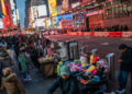 People display merchandise for pedestrians around Times Square, in New York, U.S., December 25, 2023. REUTERS/Eduardo Munoz