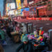 People display merchandise for pedestrians around Times Square, in New York, U.S., December 25, 2023. REUTERS/Eduardo Munoz