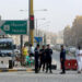 Kuwaiti police officers man a checkpoint at the entrance the town of Jeleeb Al-Shuyoukh, south the capital Kuwait City on April 7, 2020, after the district was put on lockdown. (Photo by YASSER AL-ZAYYAT / AFP)