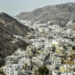 (FILES) A man stands atop a hill in al-Wadi al-Kabir west of Oman's capital Muscat on February 14, 2018 while waiting for the peloton during the second stage of the 2018 cycling Tour of Oman. Four people were killed and multiple others wounded in a shooting at the Imam Ali Mosque in the Al-Wadi Al-Kabir, police said on July 16, 2024. Such an attack is rare in the Sultanate, which has regularly played the role of mediator in regional conflicts. Shiites this week mark Ashura, an annual day of mourning that commemorates the 7th-century battlefield martyrdom of Hussein. (Photo by Philippe LOPEZ / AFP)