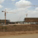 Construction work continues at the site of a soccer stadium for use in next year's African Nations Cup in the small town of Camama in this picture taken February 13, 2009. In a year in which Angola's two main exports -- oil and diamonds -- have plunged, a scene on the outskirts of the capital city of Luanda defies the notion of scaling back in bad times. Over the last few months, a massive 50,000-seater soccer stadium has risen in Camama where thousands of people live in shanty towns without running water or electricity. Picture taken February 13. To match feature SOCCER/ANGOLA    REUTERS/Henrique Almeida (ANGOLA)