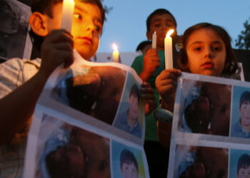 Syrian children carry pictures of 13-year-old Hamza al-Khatib and hold candles during a protest in front of the United Nations building in Beirut June 1, 2011. The Syrian boy, who activists say was tortured and killed by security forces, has emerged as a powerful symbol in protests against the rule of Syria's President Bashar al-Assad which have been met with a bloody crackdown. REUTERS/ Jamal Saidi            (LEBANON - Tags: CIVIL UNREST POLITICS)