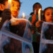 Syrian children carry pictures of 13-year-old Hamza al-Khatib and hold candles during a protest in front of the United Nations building in Beirut June 1, 2011. The Syrian boy, who activists say was tortured and killed by security forces, has emerged as a powerful symbol in protests against the rule of Syria's President Bashar al-Assad which have been met with a bloody crackdown. REUTERS/ Jamal Saidi            (LEBANON - Tags: CIVIL UNREST POLITICS)