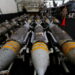 U.S Navy staff members walk next to aerial bombs at the hanger-bay aboard the USS Dwight D. Eisenhower (CVN 69) aircraft carrier in Southern Red Sea, Middle East, February 13, 2024. REUTERS/Hamad I Mohammed