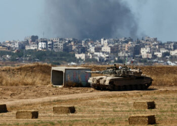 An Israeli tank holds a position as smoke rises in Gaza, amid the ongoing conflict between Israel and the Palestinian Islamist group Hamas, near the Israel-Gaza border, in Israel, May 15, 2024. REUTERS/Amir Cohen