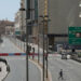 A pedestrian crosses a road near a police road block during a full lockdown, following the outbreak of the coronavirus disease (COVID-19), in the Al Ras neighbourhood in Dubai, United Arab Emirates, March 31, 2020. REUTERS/Christopher Pike